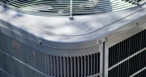 Close-up of a heat pump’s fan grille and coil