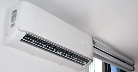 A white ductless mini-split unit mounted high on a wall