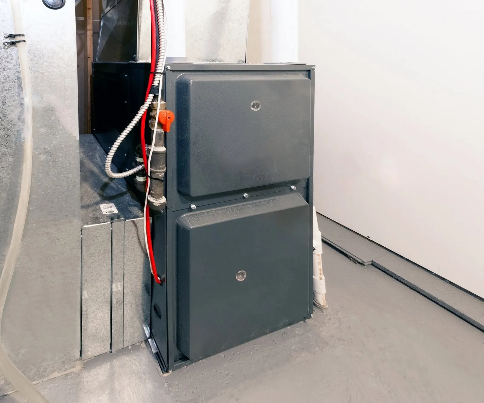 A high-efficiency gas furnace installed beside its ductwork